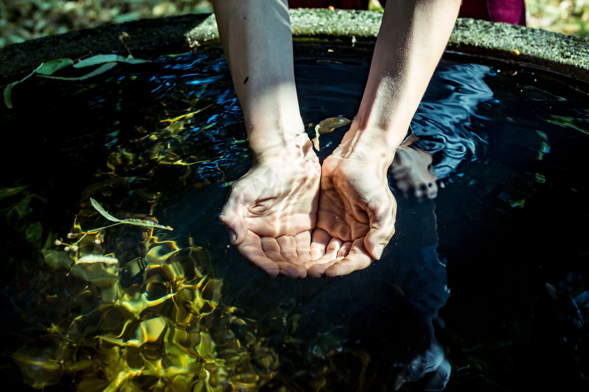 Holding water from a well  in cupped hands